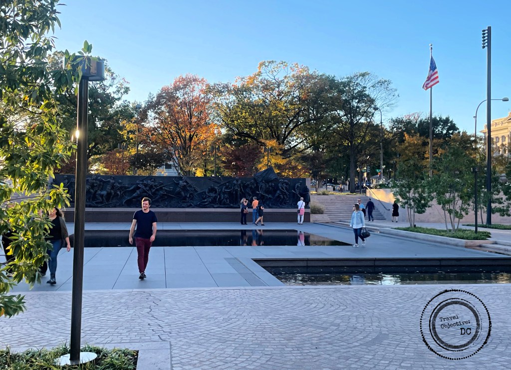 Visitors walk through an open plaza at the National World War I Memorial.