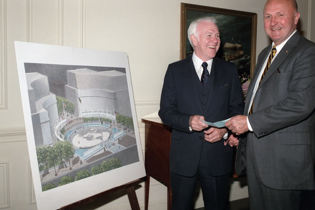 Rear Admiral William Thompson (ret.), on left, receiving a donation for the US Navy Memorial.