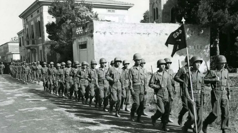 U.S. Fifth Army soldiers of Company M, 100th Infantry Battalion, 442nd Regiment march through Vada, Italy,