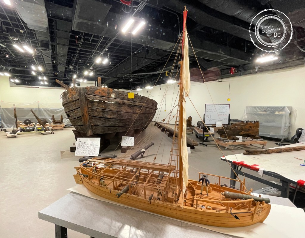 A model of the Gunboat Philadelphia is displayed alongside the actual Philadelphia undergoing restoration at the National Museum of American History in Washington DC.