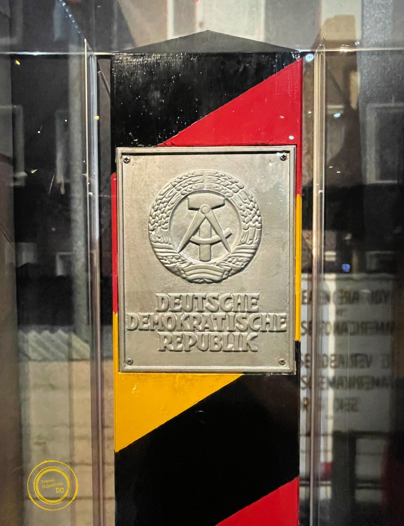 A border marker with the emblem of the German Democratic Republic.