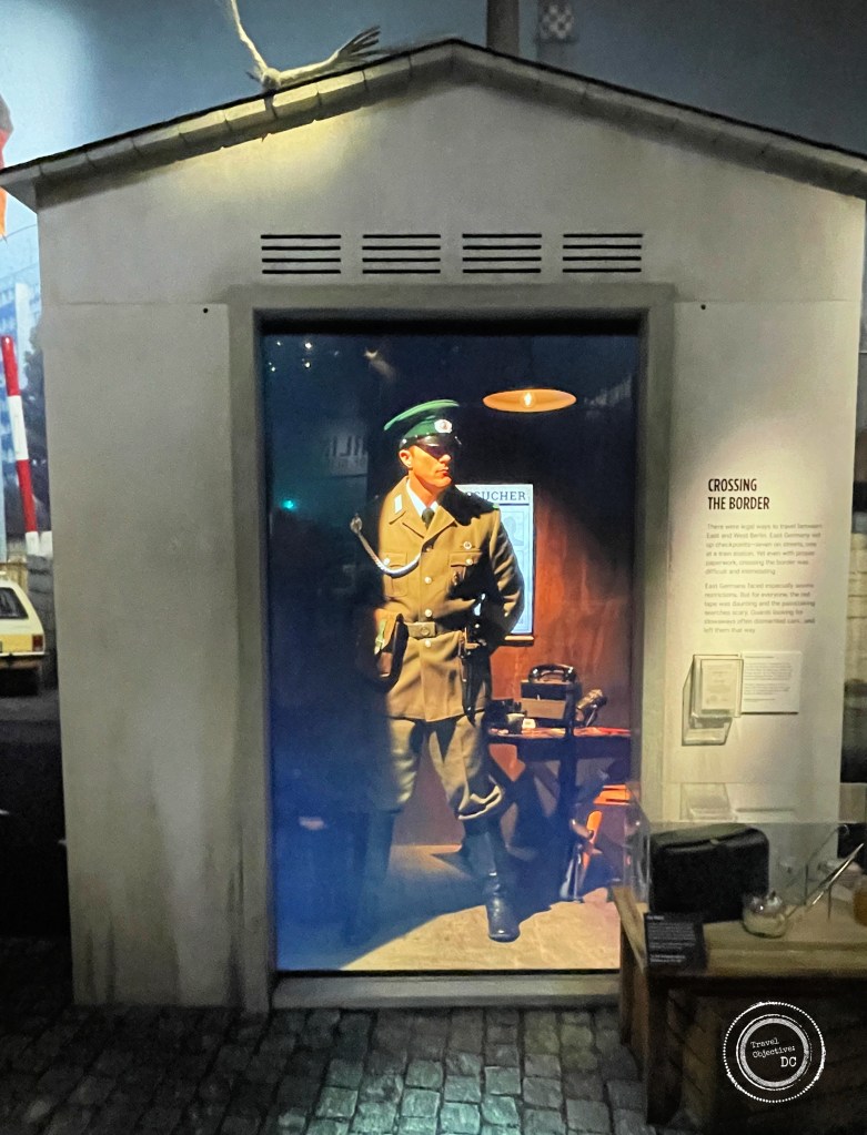 A guardhouse with an East German police officer